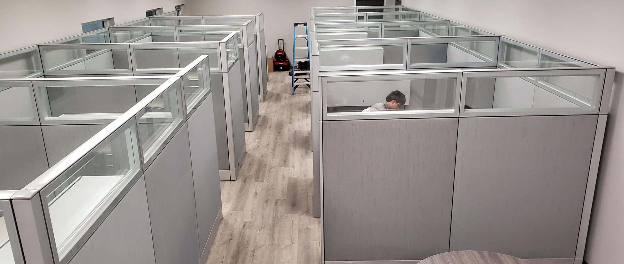 Office Funiture. Grey cubicles with clear panels in an office. Office Furniture
